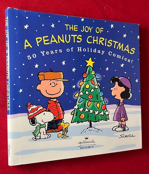 Item #5455 The Joy of A Peanus Christmas: 50 Years of Holiday Comics! Charles SCHULZ, Don HALL.