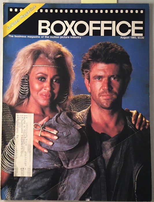 Item #620 Box Office Magazine (August, 1985) Mad Max Beyond Thunderdome Cover; EARLY REVIEW OF THE GOONIES THAT IS LESS THAN FLATTERING. Jimmy SUMMERS.